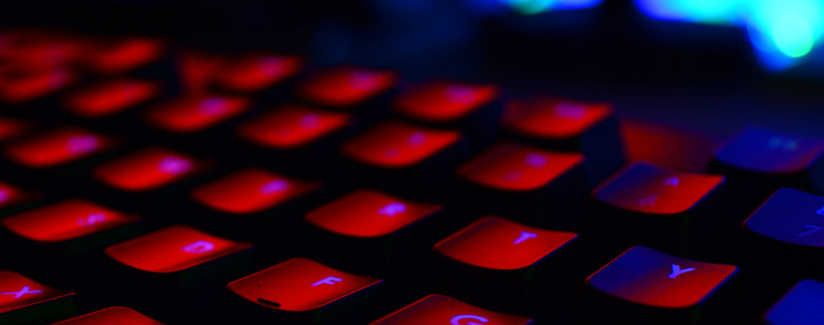 A computer keyboard, lit in red